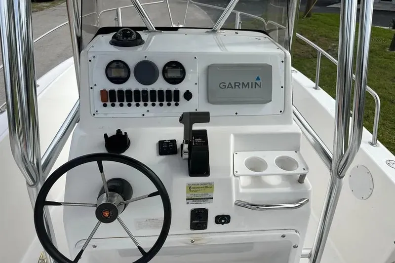 Slide: The Image of 2001 Century 2300 Center Console boat dashboard with Garmin navigation system. - 2