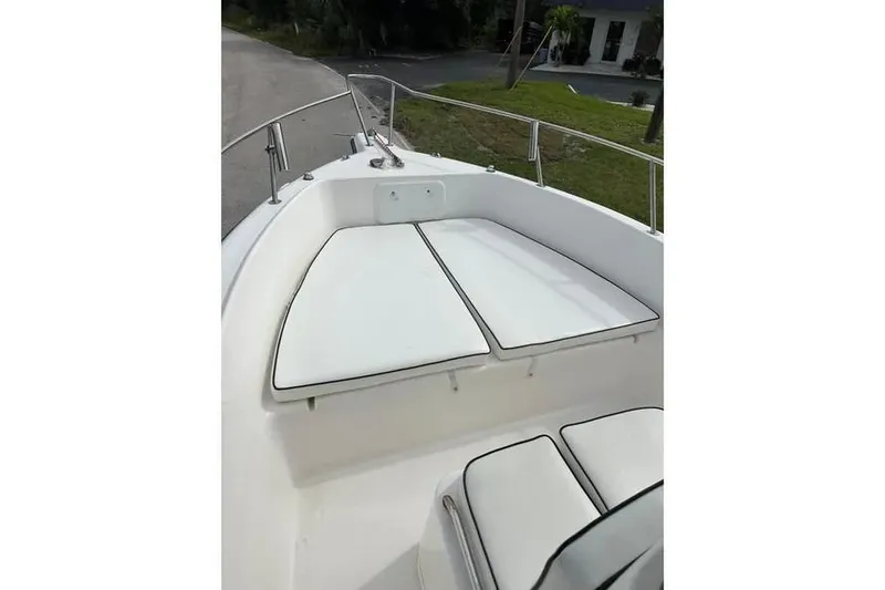 Slide: The Image of 2001 Century 2300 Center Console boat with cushioned seating and railing. - 3