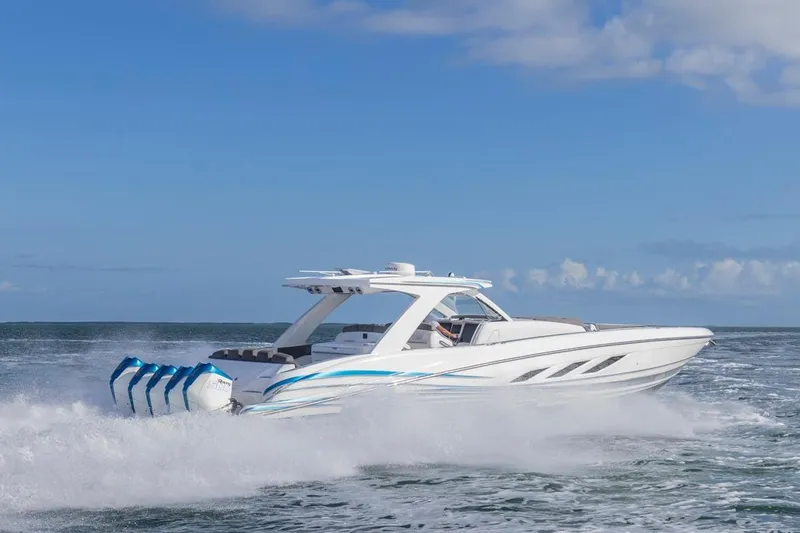 Slide: The Image of 2025 Deep Impact 499 Sport boat cruising on open water under clear blue sky. - 13