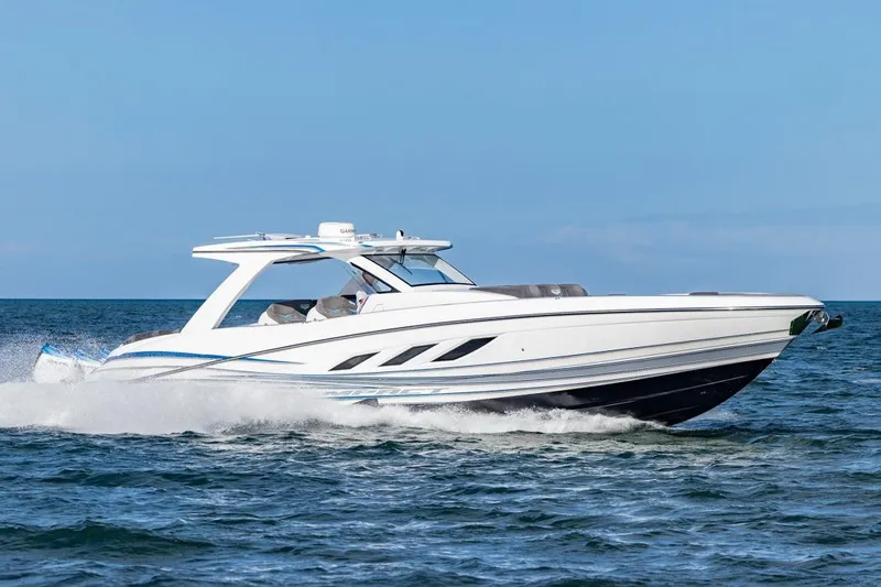 Slide: The Image of 2025 Deep Impact 499 Sport boat cruising on open water, showcasing sleek design. - 14