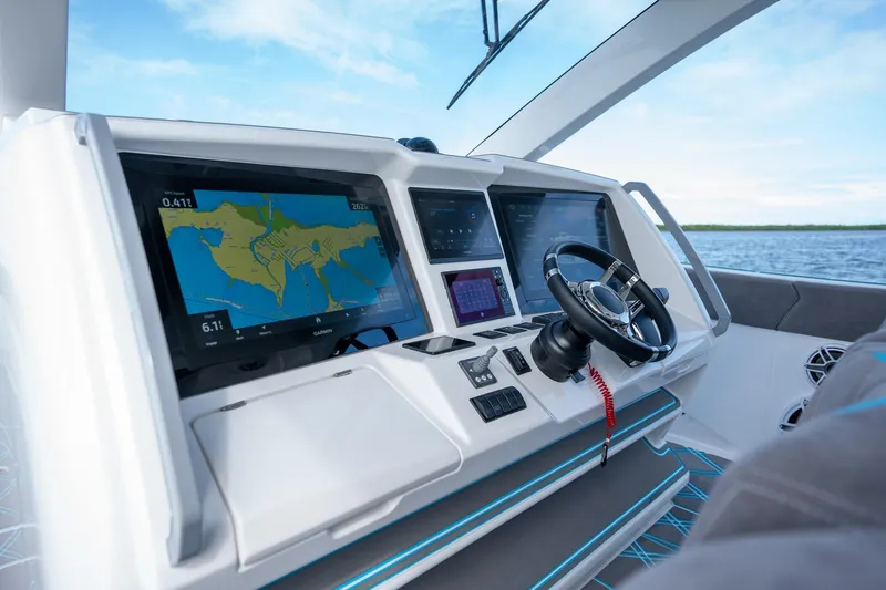 Slide: The Image of Helm of 2025 Deep Impact 499 Sport boat with advanced navigation displays. - 28