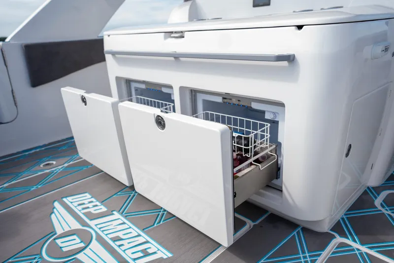 Slide: The Image of 2025 Deep Impact 499 Sport boat with open storage compartments on deck. - 41