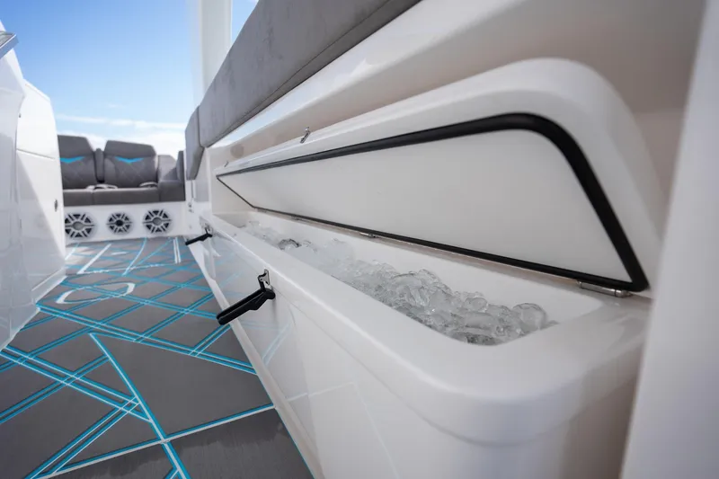 Slide: The Image of 2025 Deep Impact 499 Sport boat interior with ice-filled storage compartment and modern seating. - 44