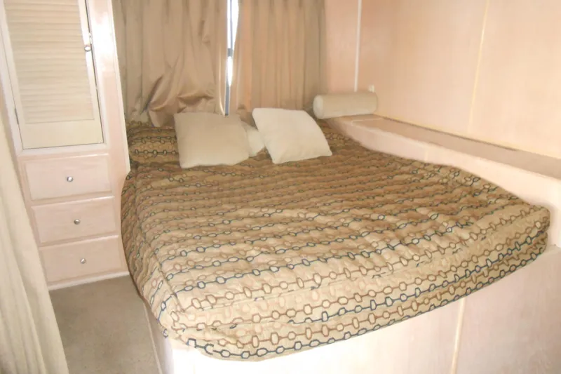 Slide: The Image of Cozy bedroom in 1993 Stardust Cruisers 5715 with patterned bedding and storage drawers. - 12