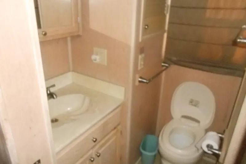 Slide: The Image of Bathroom interior of a 1993 Stardust Cruisers 5715, featuring a sink and toilet. - 15