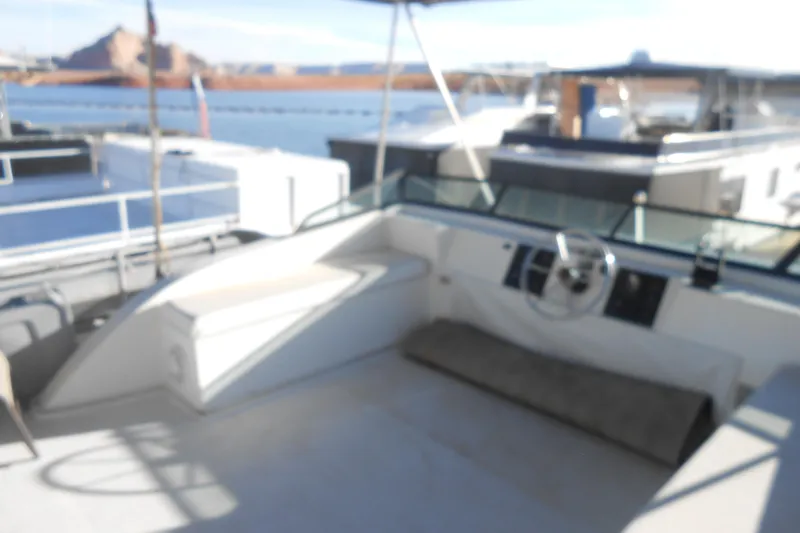 Slide: The Image of Blurry view of a 1993 Stardust Cruisers 5715 boat interior at a marina. - 17