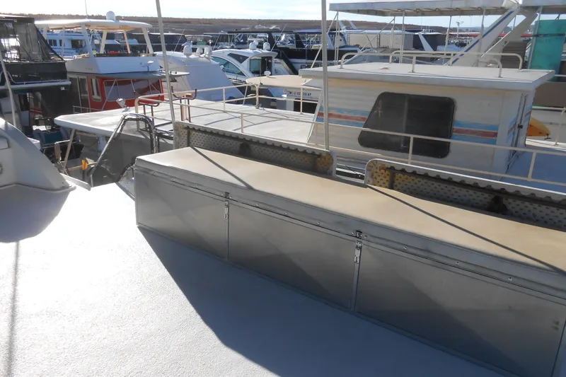 Slide: The Image of Houseboats docked at a marina, featuring a 1993 Stardust Cruisers 5715 model. - 18