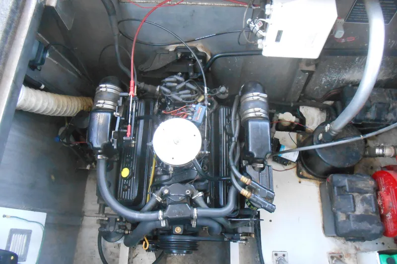 Slide: The Image of Engine compartment of a 1993 Stardust Cruisers 5715, showcasing mechanical components and wiring. - 20