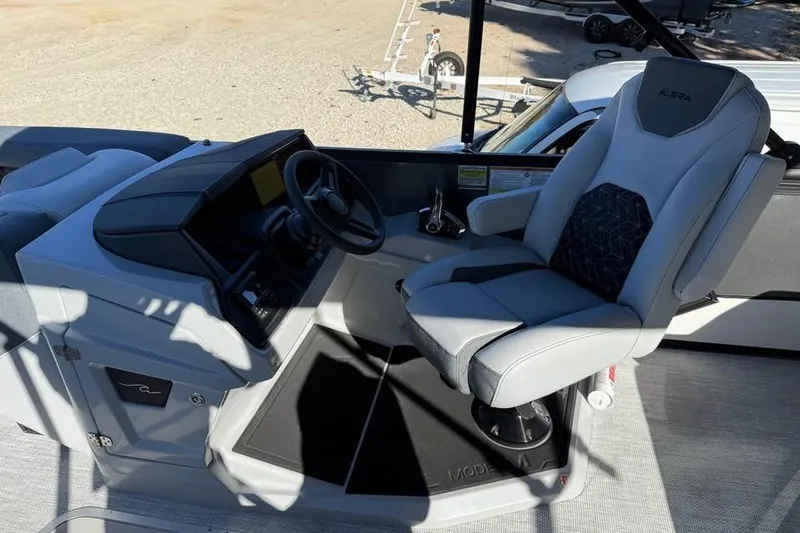 Slide: The Image of Captain's seat and helm of 2026 Alera M 23L boat, featuring modern controls and design. - 12