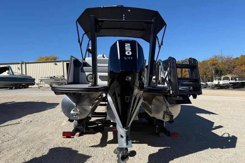 Slide: The Image of Alera M 23L 2026 pontoon boat with powerful outboard motor, parked outdoors. - 6