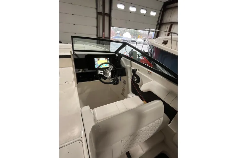 Slide: The Image of 2021 Sea Ray SDX 270 Outboard boat interior with steering wheel and dashboard. - 10