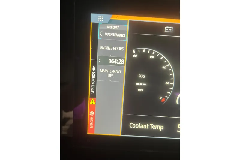 Slide: The Image of Dashboard of 2021 Sea Ray SDX 270 Outboard showing engine hours and maintenance alerts. - 12