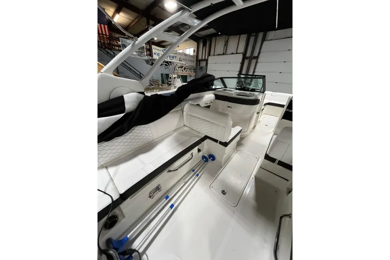Slide: The Image of 2021 Sea Ray SDX 270 Outboard interior with seating and storage in a showroom. - 14