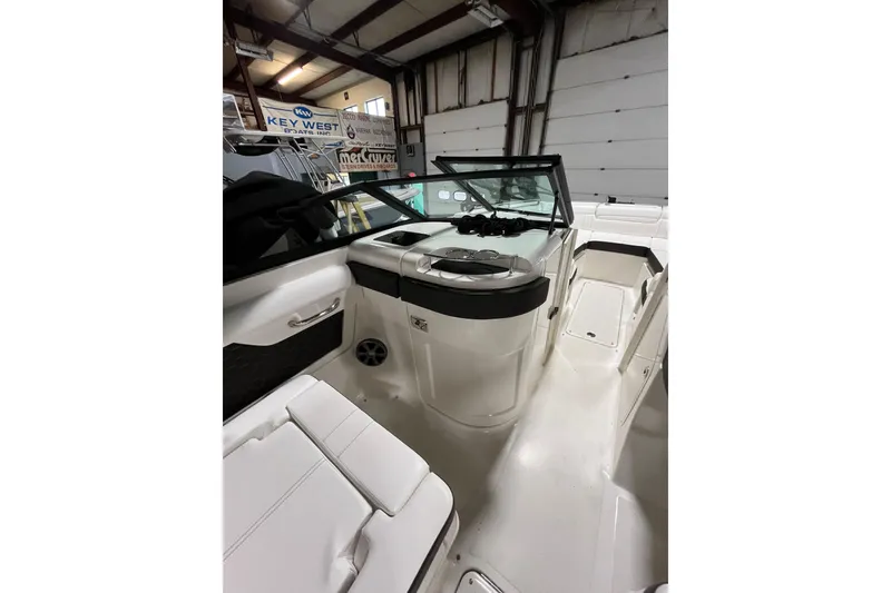 Slide: The Image of 2021 Sea Ray SDX 270 Outboard boat interior with seating and helm in a showroom. - 17