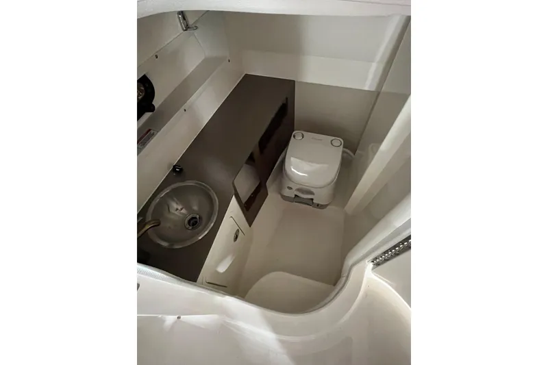 Slide: The Image of 2021 Sea Ray SDX 270 Outboard boat interior bathroom with sink and toilet. - 18