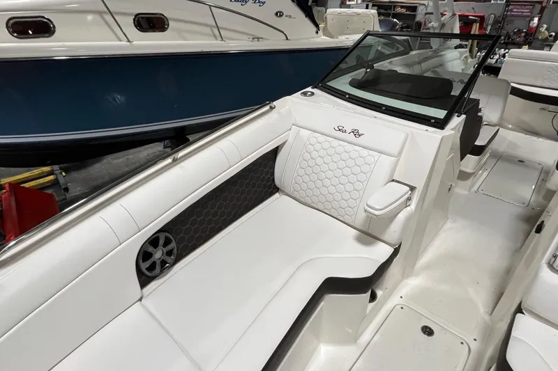 Slide: The Image of 2021 Sea Ray SDX 270 Outboard boat interior with white seating and sleek design. - 20