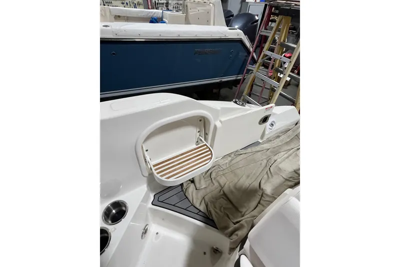Slide: The Image of 2021 Sea Ray SDX 270 Outboard boat interior with seating and storage area. - 26