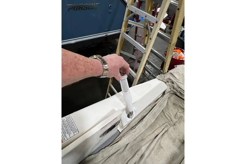 Slide: The Image of Hand operating a component on a 2021 Sea Ray SDX 270 Outboard boat. - 27