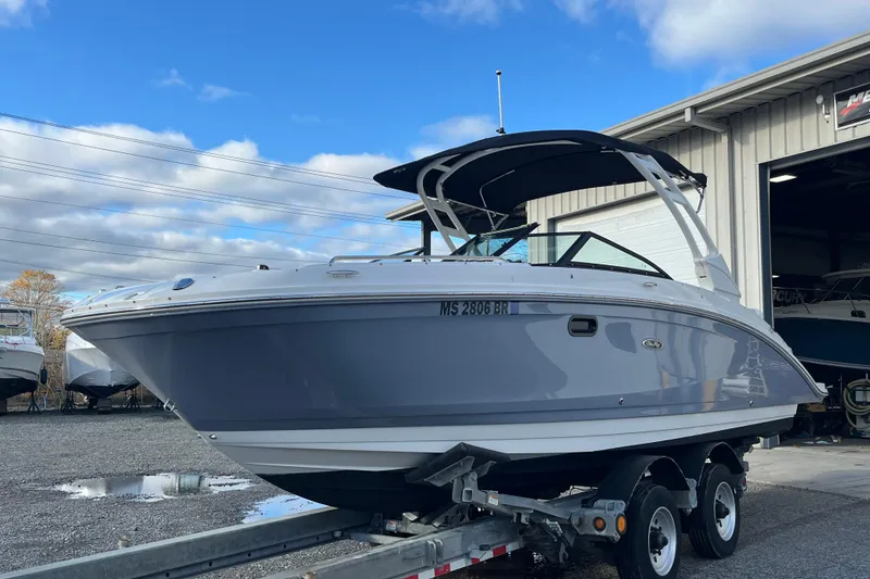Slide: The Image of 2021 Sea Ray SDX 270 Outboard boat on trailer, parked outside a garage. - 3