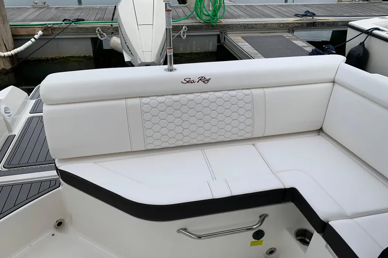 Slide: The Image of 2021 Sea Ray SDX 270 Outboard boat with white cushioned seating at dock. - 32