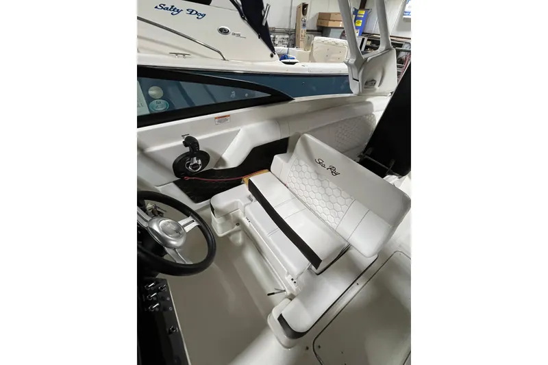 Slide: The Image of 2021 Sea Ray SDX 270 Outboard interior with white seating and steering wheel. - 34