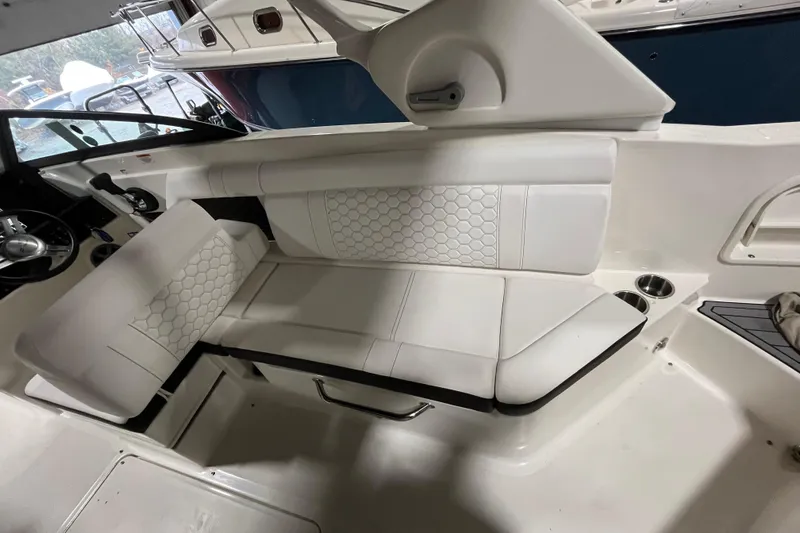 Slide: The Image of 2021 Sea Ray SDX 270 Outboard interior with white seating and modern design. - 35