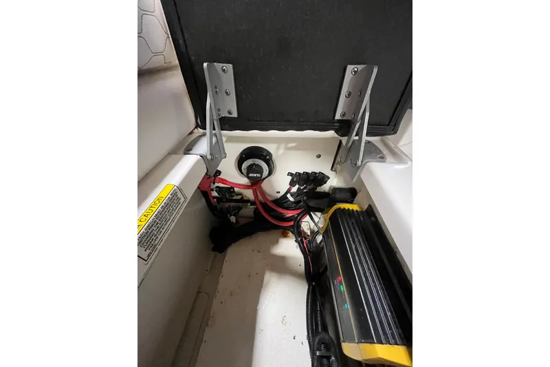 Slide: The Image of 2021 Sea Ray SDX 270 Outboard battery compartment with wiring and components. - 36