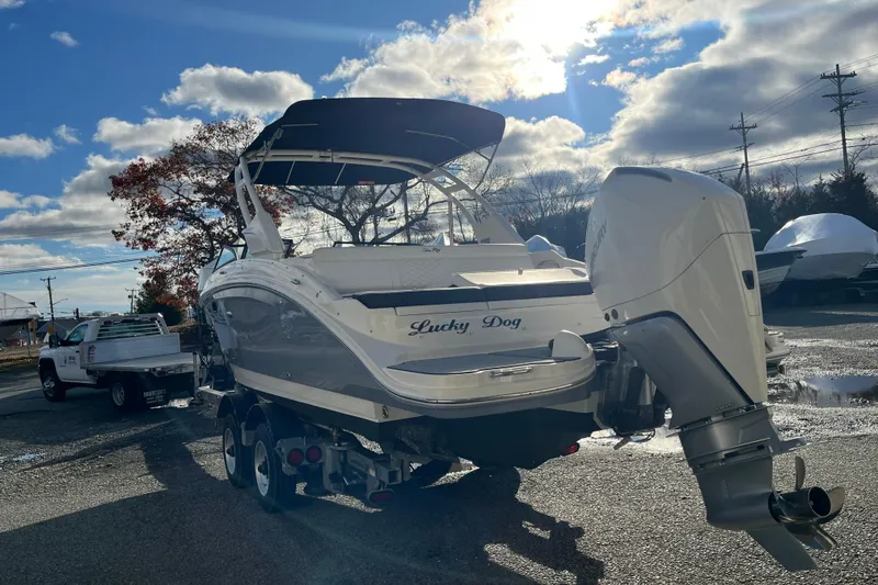 Slide: The Image of 2021 Sea Ray SDX 270 Outboard boat on trailer under sunny sky. - 5