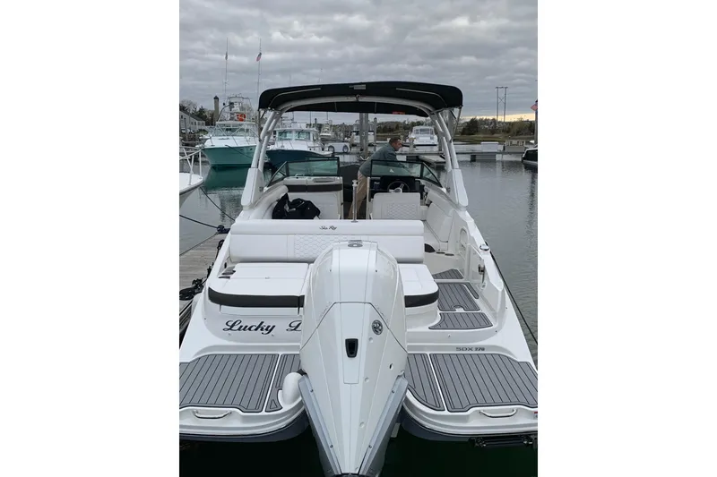 Slide: The Image of 2021 Sea Ray SDX 270 Outboard boat docked, featuring spacious seating and sleek design. - 6