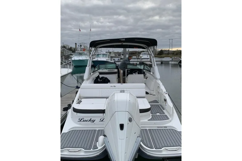 Slide: The Image of 2021 Sea Ray SDX 270 Outboard boat docked, featuring spacious seating and sleek design. - 7