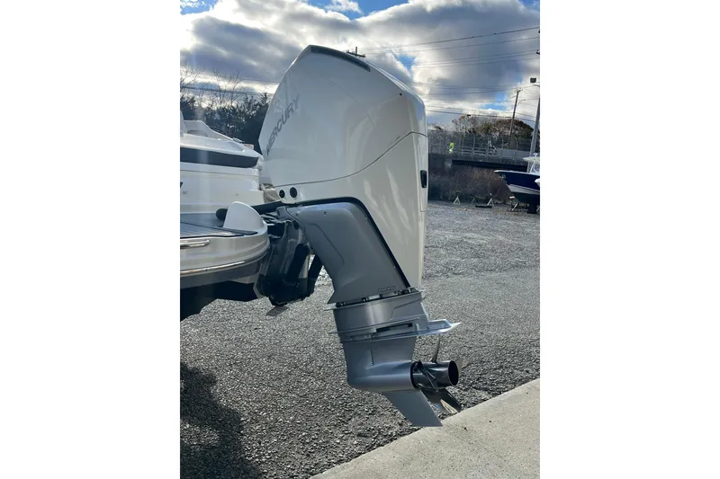 Slide: The Image of 2021 Sea Ray SDX 270 Outboard engine, parked outdoors under cloudy sky. - 9