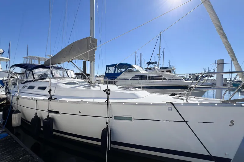 The Image of 2007 Beneteau 373 sailboat docked at marina under clear blue sky. - 0