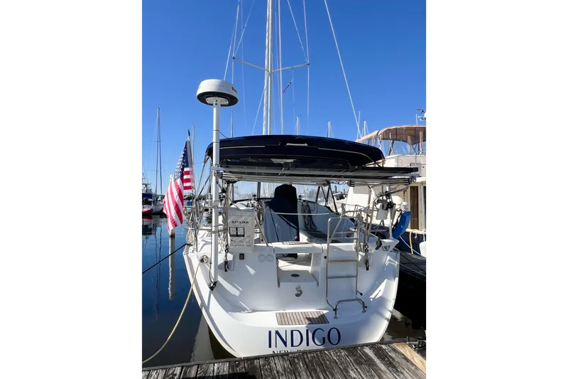 Slide: The Image of 2007 Beneteau 373 sailboat docked, featuring American flag and radar equipment. - 11