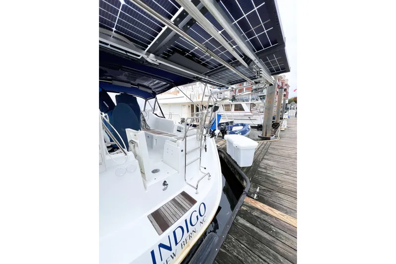 Slide: The Image of 2007 Beneteau 373 sailboat with solar panels docked at a marina. - 13