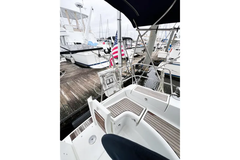 Slide: The Image of 2007 Beneteau 373 sailboat docked at marina with American flag. - 15