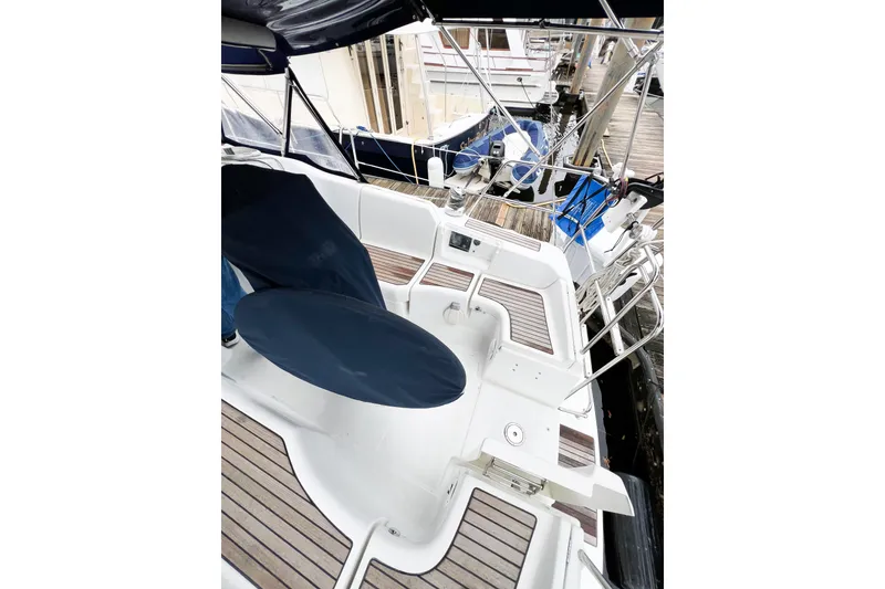 Slide: The Image of 2007 Beneteau 373 sailboat cockpit with covered steering wheel and wooden deck. - 16