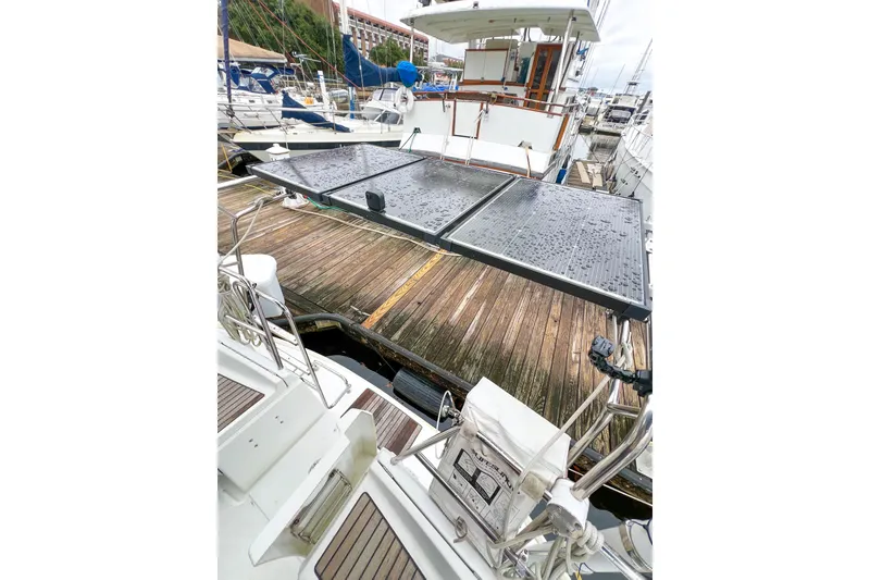 Slide: The Image of Beneteau 373 sailboat docked with solar panels, 2007 model, marina setting. - 17