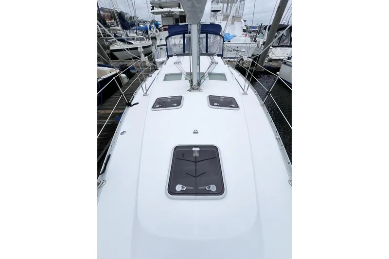 Slide: The Image of 2007 Beneteau 373 sailboat deck view at marina, showcasing sleek design and hatches. - 21
