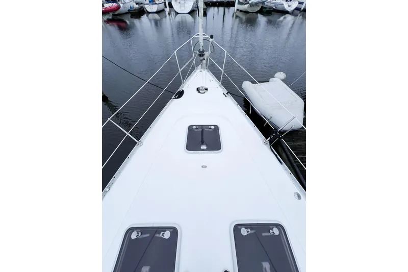 Slide: The Image of Deck view of a 2007 Beneteau 373 sailboat docked at a marina. - 22