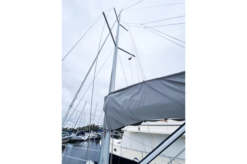 Slide: The Image of Sailboat mast of 2007 Beneteau 373 in marina, overcast sky. - 25