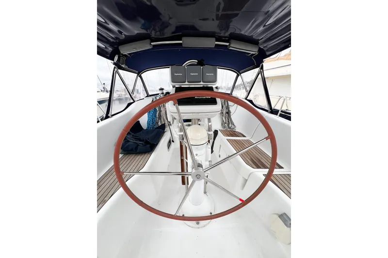 Slide: The Image of 2007 Beneteau 373 sailboat cockpit with steering wheel and navigation equipment. - 26
