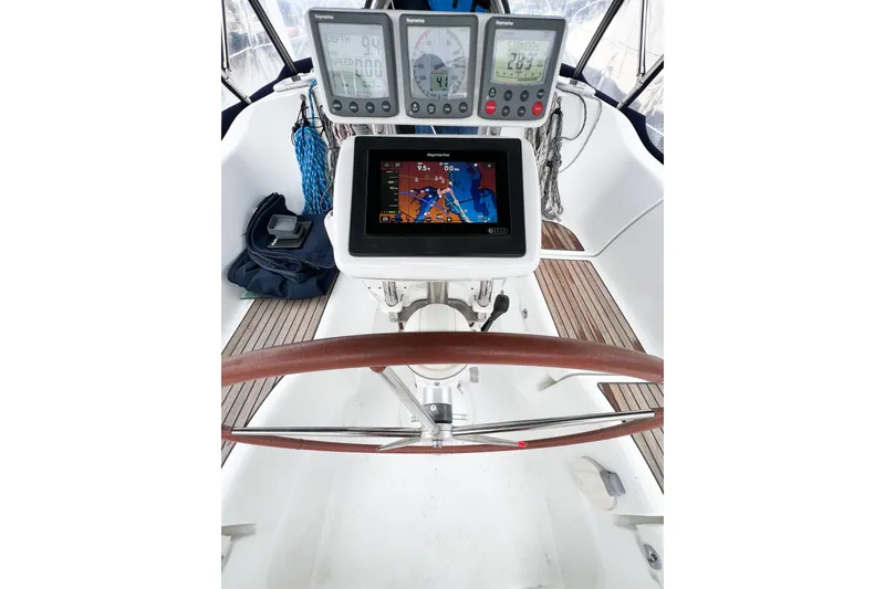 Slide: The Image of Cockpit of 2007 Beneteau 373 sailboat with navigation instruments and wooden steering wheel. - 30