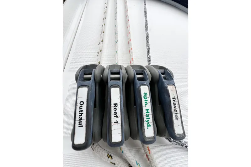 Slide: The Image of Sailboat control lines labeled outhaul, reef, spin halyard, traveler on 2007 Beneteau 373. - 34