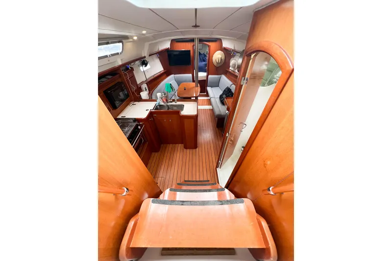 Slide: The Image of Interior of 2007 Beneteau 373 sailboat with wooden finish and cozy seating area. - 36