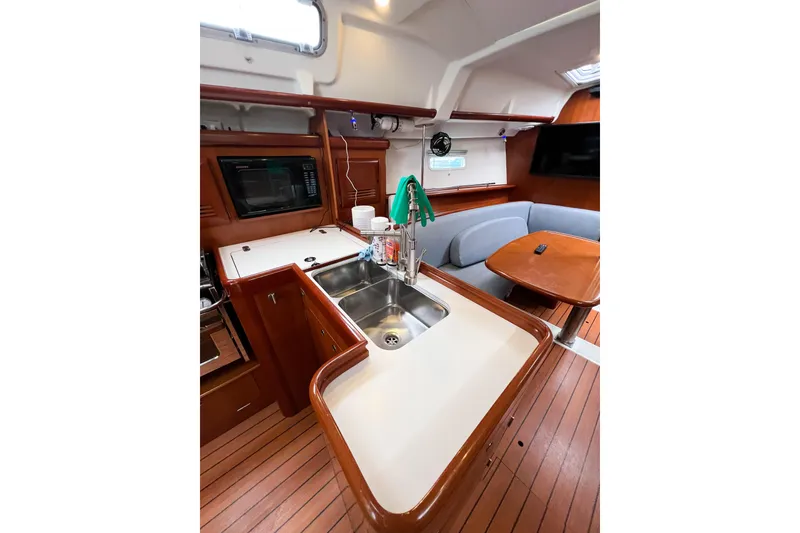 Slide: The Image of Interior of 2007 Beneteau 373 sailboat with kitchen and seating area. - 41