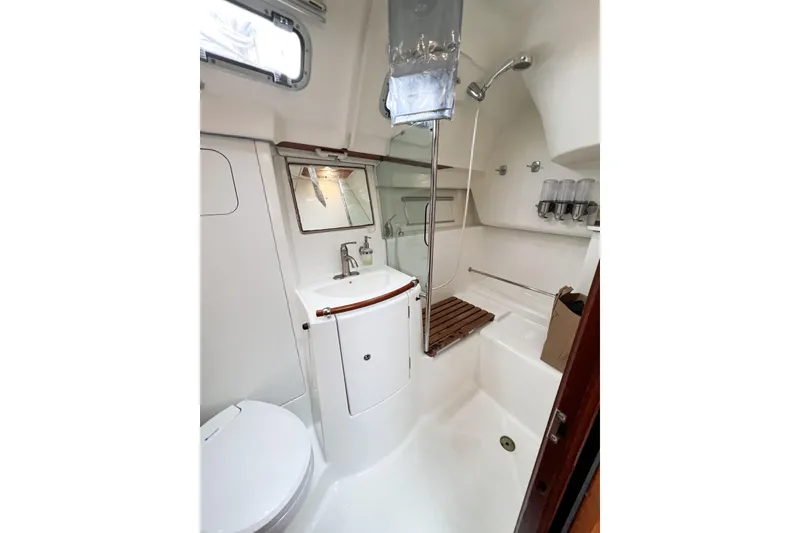 Slide: The Image of 2007 Beneteau 373 yacht bathroom with shower, sink, and toilet. - 42