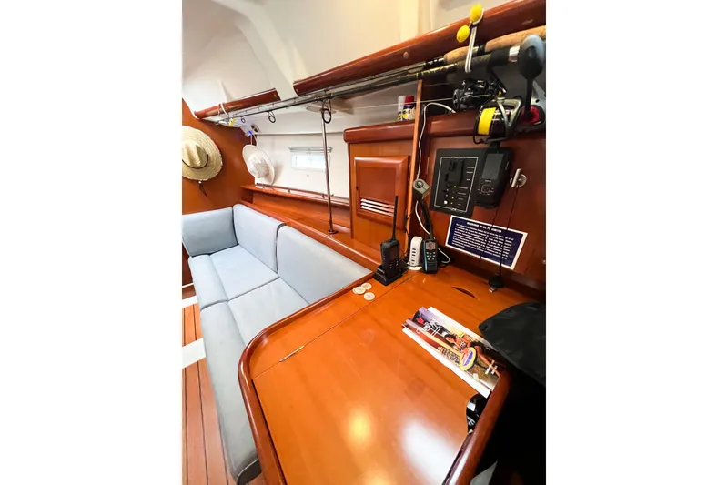 Slide: The Image of Interior of 2007 Beneteau 373 sailboat with wooden table and blue seating. - 46