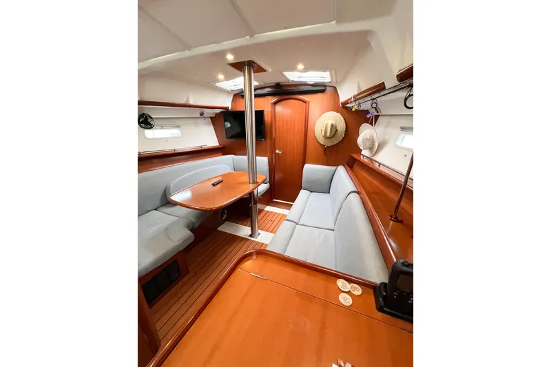 Slide: The Image of Interior of 2007 Beneteau 373 sailboat with cozy seating and wooden finishes. - 47