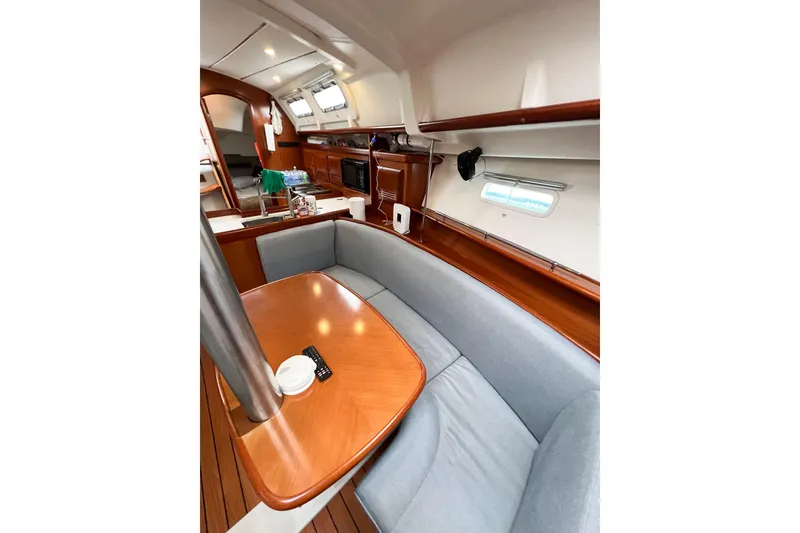 Slide: The Image of Interior of 2007 Beneteau 373 sailboat with cozy seating and wooden table. - 48