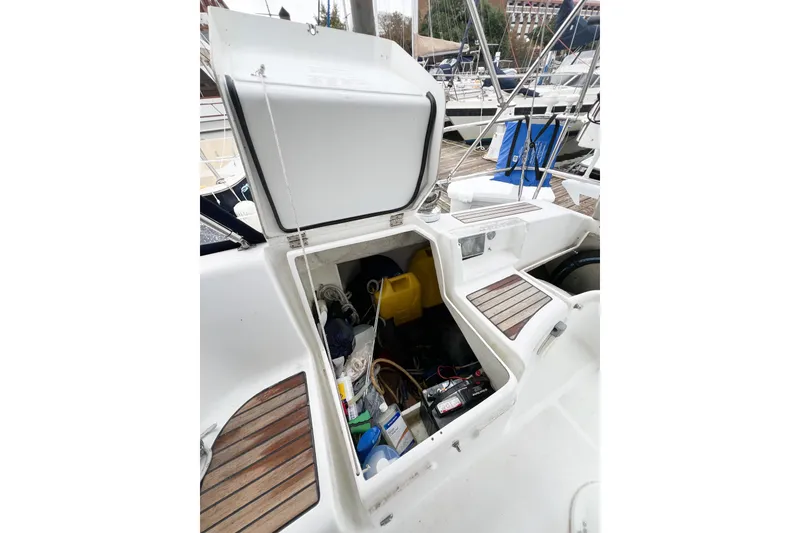 Slide: The Image of Open storage compartment on a 2007 Beneteau 373 sailboat, showing equipment and supplies. - 49